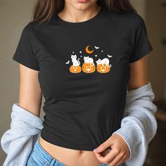 Black Cat Crop Top, Halloween Pumpkin Baby Tee, Spooky Season Baby Tee,Trendy Halloween Baby Tee, Horror Crop Top, Scary Fall Crop Top, T104 🌸 Welcome to Pinky Tee Store! We strive to provide you with the best shopping experience possible. Thank you for choosing us!" 👉 Ordering Process: 📸 Thoroughly examine all the available photos. 📏 Select your item's size. 🎨 Choose your preferred color. 🔢 Specify the desired quantity. 🛒 Add the selected item to your cart. 💳 Proceed to checkout to finalize your order. 👉 Product Features: Sweatshirts: 👕 Made from a blend of 50% cotton and 50% polyester. 🧵 Features a 1x1 ribbed collar, cuffs, and spandex waistband for added durability. 🚻 Unisex size. Shirts: 👕 Unisex t-shirt that fits like a cherished favorite, with a crew neck made from super Black Y2k T-shirt For Halloween, Black Y2k Style T-shirt For Halloween, Black Y2k Tops With Cartoon Print, Fitted Black Cartoon Print Tops, Y2k Black Top With Cartoon Print, Y2k Style Black Top With Cartoon Print, Fitted Black Top With Cartoon Print, Black Cartoon Print Y2k Top, Y2k Fitted Halloween T-shirt