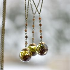 This necklace features preserved moss and a tiny alder pinecone forever suspended in the clear eco-resin. The sphere is complemented with a brass top and comes on 25 inches brass chain, adorned with small natural jaspers.   The sphere measures about 1 inch in diameter. Loose My Mind, Amber Necklace Baby, Sphere Necklace, Into The Forest I Go, Pinecone Necklace, Terrarium Jewelry, Terrarium Necklace, Into The Forest, Eco Resin