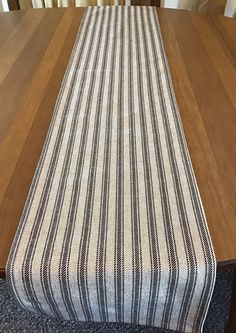 a striped table runner on top of a wooden table