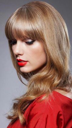 a woman with long hair and red lipstick on her face, wearing a red dress