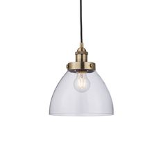 a clear glass light hanging from a ceiling fixture with a gold metal frame and black cord