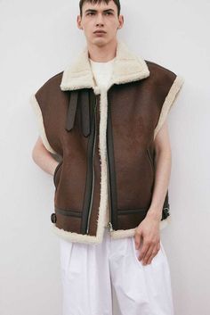 Men's RAF B3 Bomber Brown Fur Shearling Sheepskin Leather Vest  ✅ Material: Made With Finest Quality Real Leather ✅ Zipper closure closure ✅ Internal: Genuine Shearling Fur  ✅Pockets:Two Outside & Two Inside Pockets ✅ Color: Black ✅ No Hassle Returns & Refunds, 30 Days Money Back Guarantee, 100% Satisfaction and Top Customer Service. ✅ Detailed Size Chart Has Been Attached For Perfect Fitting.Kindly Select Your Size Efficiently. When selecting a size, please leave at least 5-6 inches from body m Belt Wide, Custom Leather Jackets, Fringe Leather Jacket, Collar Vest, Shearling Vest, Brown Jacket, Leather Vest, Oversized Silhouette, Leather Outfit