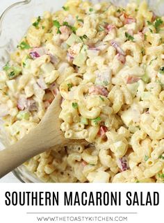 a bowl full of macaroni salad with a wooden spoon in it and the words southern macaroni salad