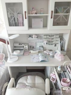 a white desk topped with lots of drawers next to a baby's crib