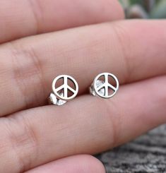 Peace Sign Earrings details:-.925 Solid Sterling Silver.-Matching Sterling butterfly backs.-Measures 6mm round.-Comfortable and lightweight Connect with us on Instagram @a_wild_violet for sales and giveaways!**All items are in stock and ship within 2-5 business days from received payment (excluding Saturday/Sunday) from the US. If you are within the US please expect 3-7 business days for shipping transit and delivery. International orders please expect a minimum of 2 weeks for delivery and upwar Peace Sign Earrings, Y2k Earrings, Hippie Earrings, Saturday Sunday, Peace Sign, Hippie Style, Shop Earrings, Ring Sets, Violet