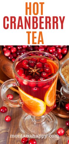 cranberry tea in a glass mug with orange slices and cinnamon on the side