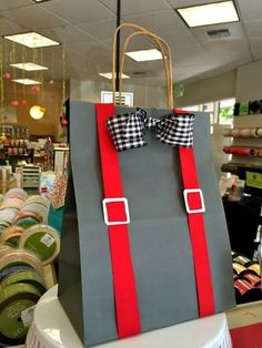 a shopping bag with a bow on it sitting on top of a table in a store