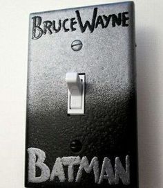 a batman light switch cover with the words bruce wayne on it