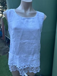 In lightly used , excellent vintage condition . Beautiful Italian linen with pretty lace and embroidery details at hem .  Tagged L but better fits up to a Medium. There are back panels of stretchy cotton which make this blouse comfortable to wear and fits nicely to your form .  Laid flat armpit to armpit measures 49cm ,  Waist approximately 48cm ,  Total length is 62cm . Fitted Lace Patchwork Casual Tank Top, Fitted Casual Tank Top With Lace Patchwork, Sleeveless Lace Tops With Broderie Anglaise, White Sleeveless Cotton Lace Top, White Cotton Lace Sleeveless Top, Fitted Cotton Lace Tops With Crochet Trim, Fitted Tops With Cutwork Hem For Summer, Spring Cotton Lace Sleeveless Top, Spring Sleeveless Cotton Lace Top