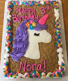 a birthday cake decorated with an image of a unicorn