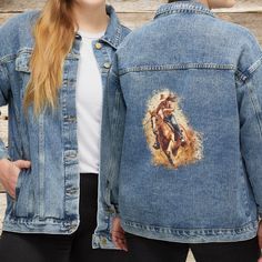 a woman wearing a jean jacket with an image of a cowboy riding a horse on it