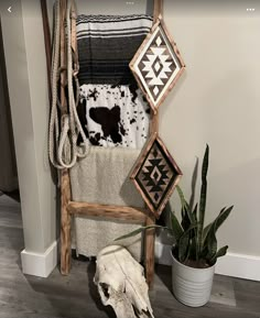 a cow skull is sitting on the floor next to a towel rack and other items