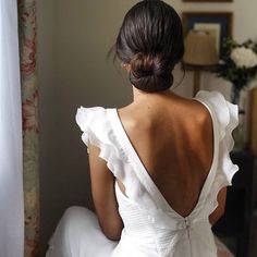 the back of a woman in a white dress