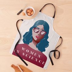 an apron with a woman's science poster on it next to eggs and utensils