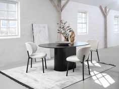 a black table with four white chairs around it