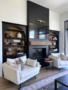 a living room filled with furniture and a fire place in the middle of the room