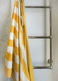 a yellow and white towel hanging on a rack