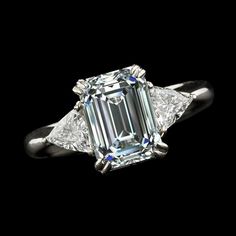 METAL SPECIFICATIONS White Gold 14K STONE SPECIFICATIONS Stone Name : Diamond Stone Cut : Emerald and Trillion Stone Details : There is one emerald cut diamond approx. 5.75 carats (Approx. Size 11 x 9 mm) and two trillion diamonds approx. 0.75 carats each (Approx. Size 6.2 x 6.2 x 6.2 mm) on the sides. Natural earth mined diamonds. Color : F/G Clarity : VS1/VVS1 Total : Approx. 7.25 Carats RING SPECIFICATIONS Size : 6.5 (Can ship in any size) Appraised Value : $117198.00 Comes with Certificate Emerald Cut Halo, Trillion Diamonds, Real Diamond Rings, Emerald Diamond Ring, Aquamarine Engagement Ring, Emerald Cut Diamond, Emerald Cut Diamonds, Three Stone Rings, Natural Earth