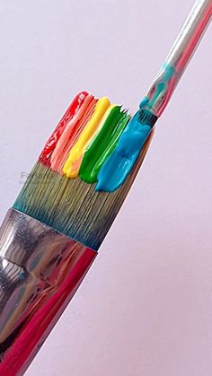 a multicolored toothbrush with different colored bristles