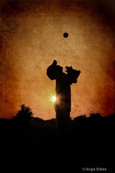 the silhouette of a person throwing a ball into the air