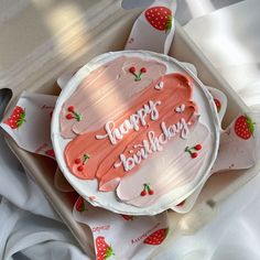 a birthday cake with strawberries on it and the words happy birthday written in frosting