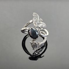 "This bat ring is made by us out of nickle free sterling silver. The bats measures 5/16\" tall x 1/2\" wide. The stone is a 6x8mm oval hematite." Silver Bird Ring, Vampire Ring, Weddings Rings, Bat Ring, Witch Rings, Hematite Ring, Magical Jewelry, Gothic Rings, Jewelry Fashion Trends