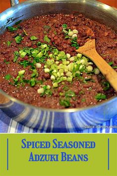 a pot filled with beans and green onions