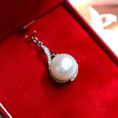 "Jewelry is the one thing that has the power to make you feel absolutely unique and elegant. Dazzle yourself and everyone around you with this cute and lustrous South Sea Pearl pendant. Featuring a RARE, LUSTROUS 12 mm Natural, Round, White South Sea Pearl, accented by 15 pieces of Brilliant Round diamonds weighing at 0.10 carat. Set in 18K solid white gold, handcrafted by professional goldsmith. All gems have been selected and graded for their unsurpassed quality and authenticity. FOR MATCHING Fine Jewelry Pearl Necklace As Gift, Elegant Pearl Necklace As Gift For Her, Elegant Pearl Necklace For Her, Akoya Pearl Pendant Necklace Gift, White Gold Sterling Silver Pearl Pendant Jewelry, Sterling Silver White Gold Jewelry With Pearl Pendant, White Gold Pendant With Pearl Charm, White Gold Pendant Jewelry With Pearl Charm, Exquisite Pearl White Pearl Necklace Gift