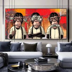 three monkeys with glasses on their heads are sitting in front of a couch and coffee table