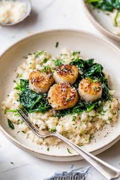 two plates filled with rice and seared scallops