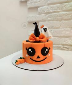 there is a cake decorated to look like a jack - o'- lantern and ghost