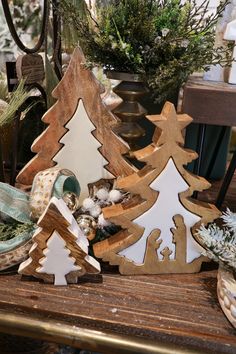 wooden christmas trees sitting on top of a table