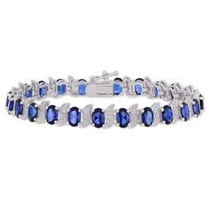 Keep it stylish and elegant with Created Blue Sapphire and Diamond Accent Oval S-Link Tennis Bracelet. Crafted in glittering sterling silver, it features 24 oval-cut, prong-set created blue sapphire gemstones (6 x 4mm) with three round-cut, pave-set diamonds (H-I, I3) studded in a s-link motifs. Enhanced with a high polish finish, this bracelet measures 7-inches in length and secures with pressure tongue clasp for a longer durability. Be it an evening party, a business meeting or a casual outing Luxury Blue Oval Diamond Bracelet, Blue Diamond Bracelet For Formal Occasions, Formal Blue Oval Diamond Bracelet, Elegant Blue Diamond Sterling Silver Bracelet, Blue Oval Diamond Bracelet For Anniversary, Elegant Blue Diamond Bracelet In Sterling Silver, Blue Oval Bracelet For Anniversary, Blue Oval Tennis Bracelet For Formal Occasions, Blue Oval Bracelets For Anniversary