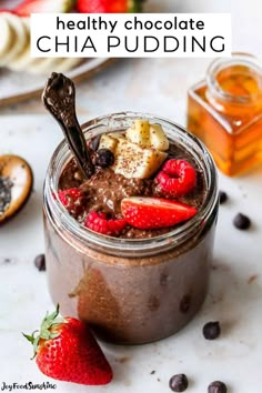 chocolate chia pudding in a glass jar with strawberries and bananas on the side