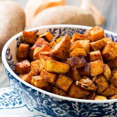 a blue and white bowl filled with cubed potatoes