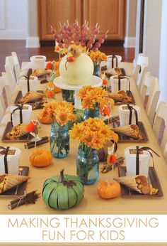 a table set for thanksgiving dinner with pumpkins and flowers