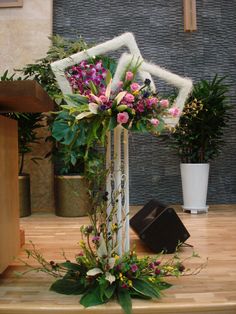 a flower arrangement is displayed in front of a mannequin