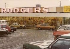 cars parked in front of a building with a sign that says roger's on it