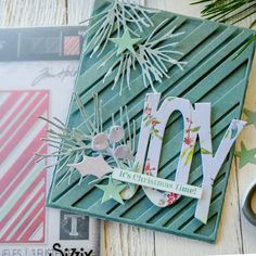 a close up of a christmas card on a table with scissors and other items around it