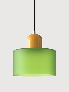 a green and yellow light hanging from a ceiling