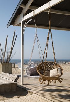 an empty swing chair on the beach in black and white