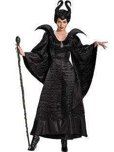 a woman dressed as maleficent holding a staff