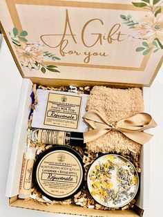 an open gift box containing soaps, body scrubs and lotion