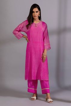 Rani pink kurta with zardozi, sequin placement embroidery. Paired with straight fit pant and dupatta.
Components: 3
Pattern: Embroidery
Type Of Work: Zardozi, sequin
Neckline: Keyhole
Sleeve Type: Three quarter
Fabric: Chanderi Mul, Cotton Silk
Color: Pink
Other Details: 
Lace embellished pant hem
Length:
Kurta: 45 inches
Pant: 37 inches
Dupatta: 2.4 mtrs
Occasion: Sangeet - Aza Fashions Embroidery Zardozi, Placement Embroidery, Chanderi Dupatta, Pink Kurta, Rani Pink, Kurta Pant Set, Straight Fit Pants, Pattern Embroidery, Kurta With Pants