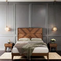 a bedroom with gray walls and wooden furniture, including a large bed in the center