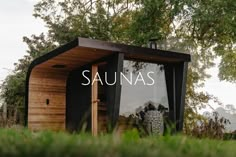 the saunas logo is displayed in front of a small wooden structure with grass and trees around it