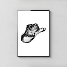 a black and white drawing of a hat hanging on a wall next to a lamp