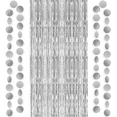 silver foiled beads hanging from the side of a curtain with metallic circles on it