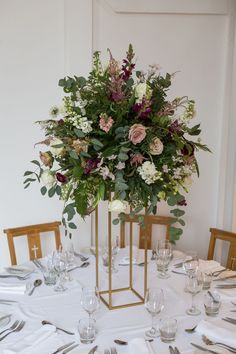 the centerpiece is filled with flowers and greenery