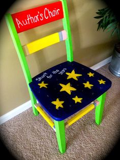 a green chair with yellow stars painted on it and a red sign that says author's chair